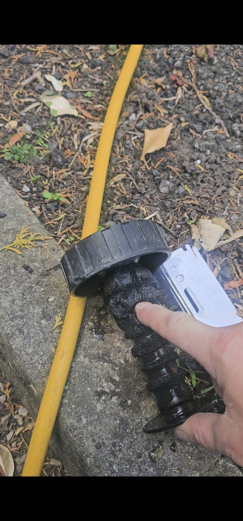 Magnetic filter with debris buildup, demonstrating the need for system cleaning and maintenance for heating efficiency.