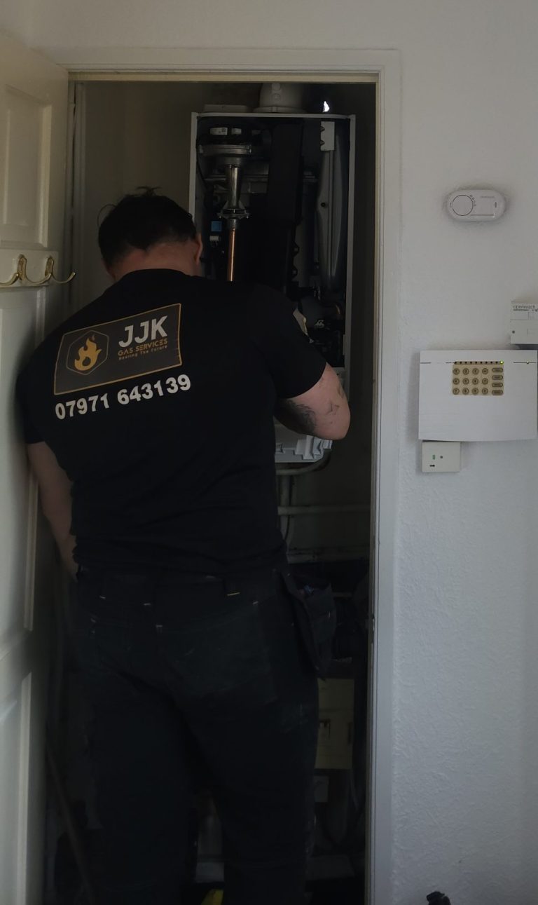 Gas engineer from JJK Gas Services performing boiler service in Wigan home